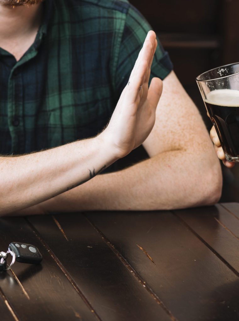 man-refusing-glass-rum-offered-by-his-friend